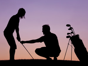 silhouette of golfer and instructor